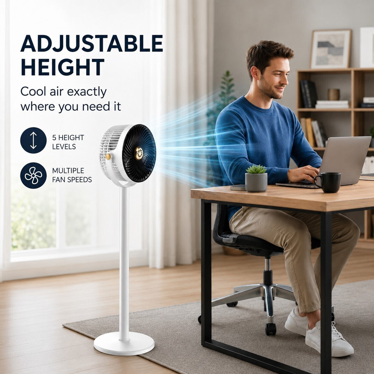 A white adjustable pedestal fan stands on a rug in a home office setting next to a man sitting at a desk using a laptop. The image includes promotional text highlighting adjustable height and multiple fan speeds.